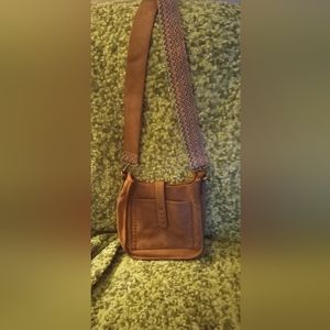 Leather guitar strap purse.